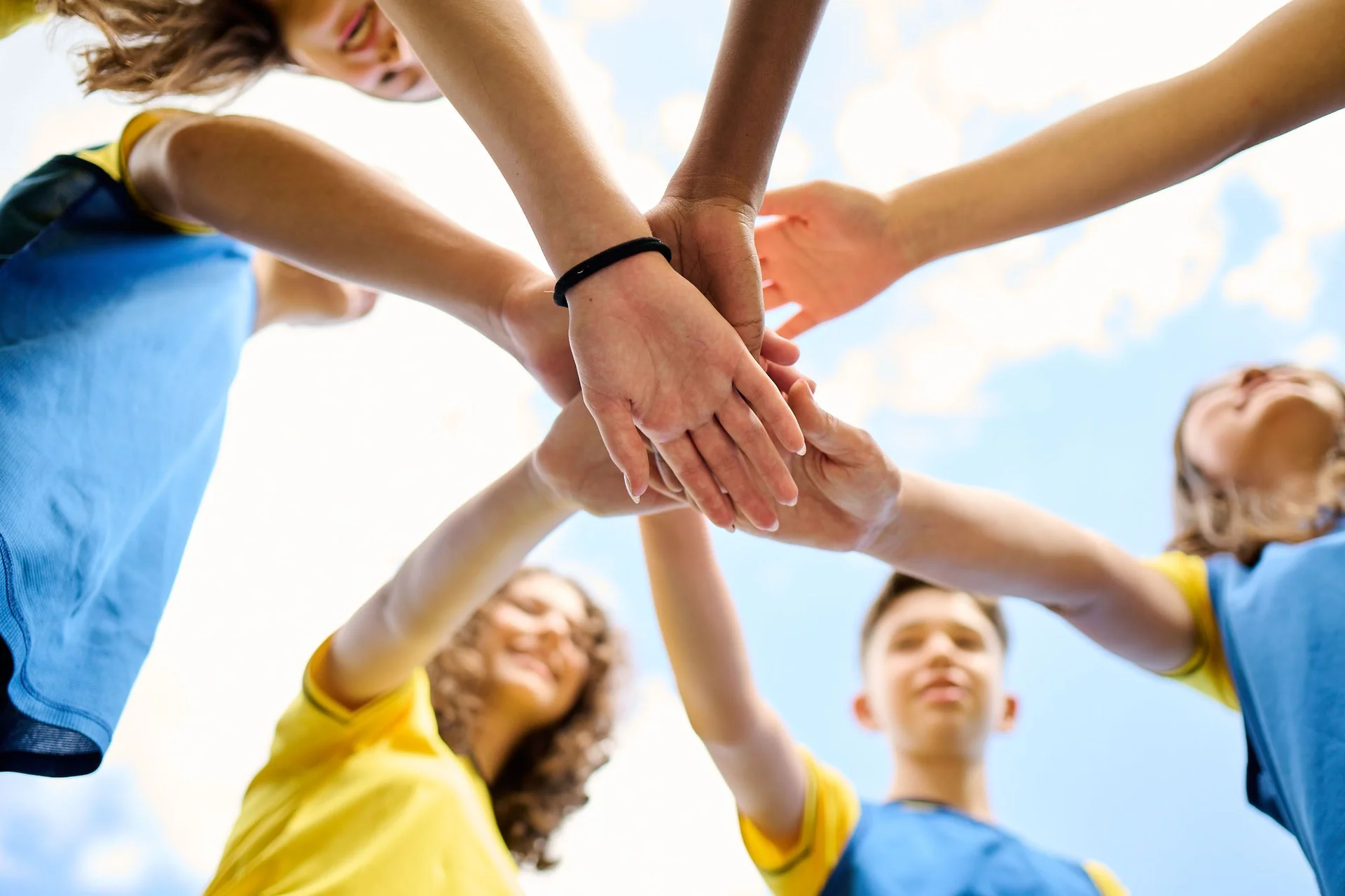Students' hands one on top of the other