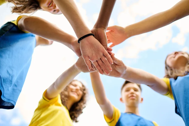 Students' hands one on top of the other