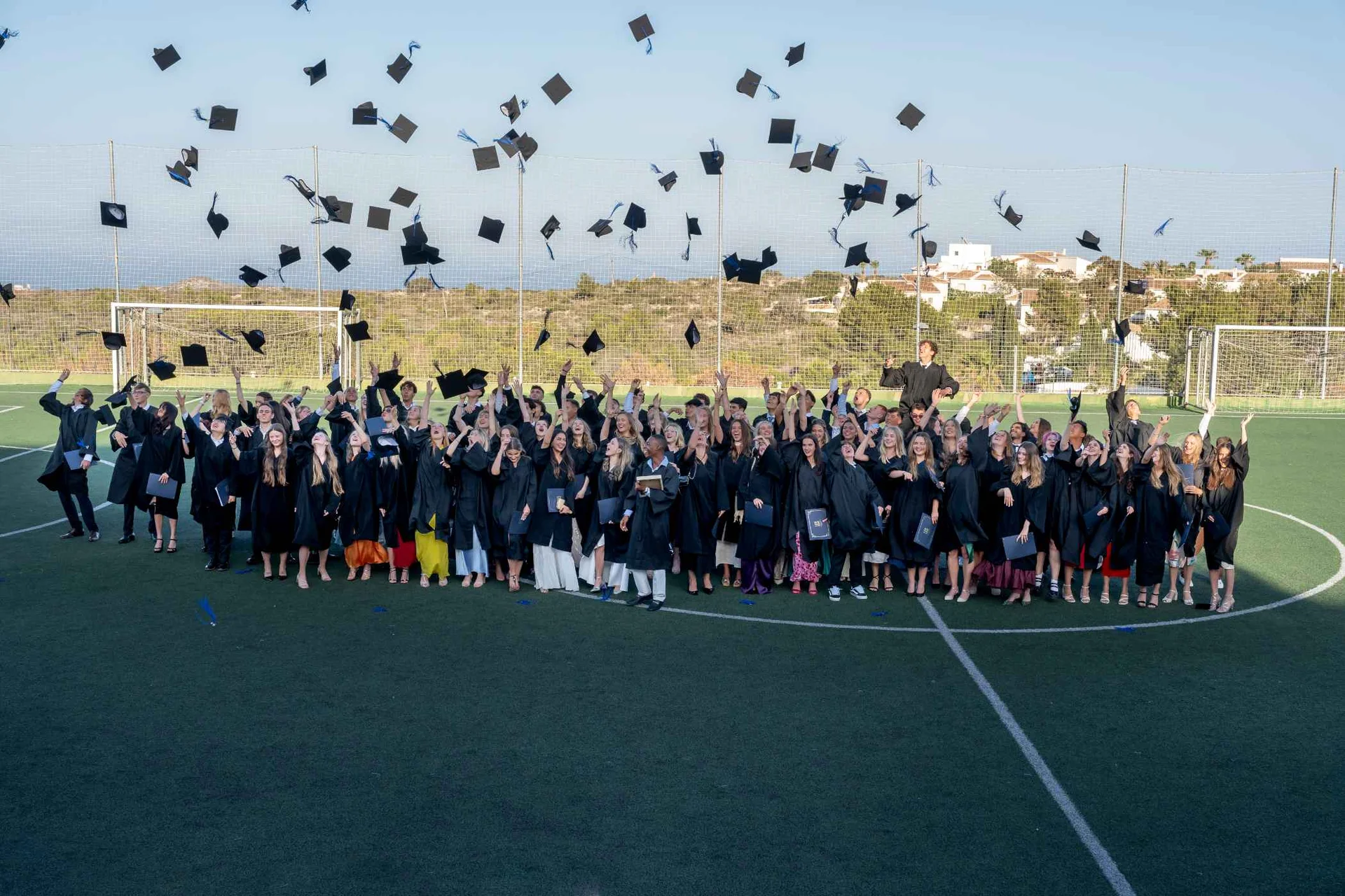 Students throwing hats in the air on graduation day