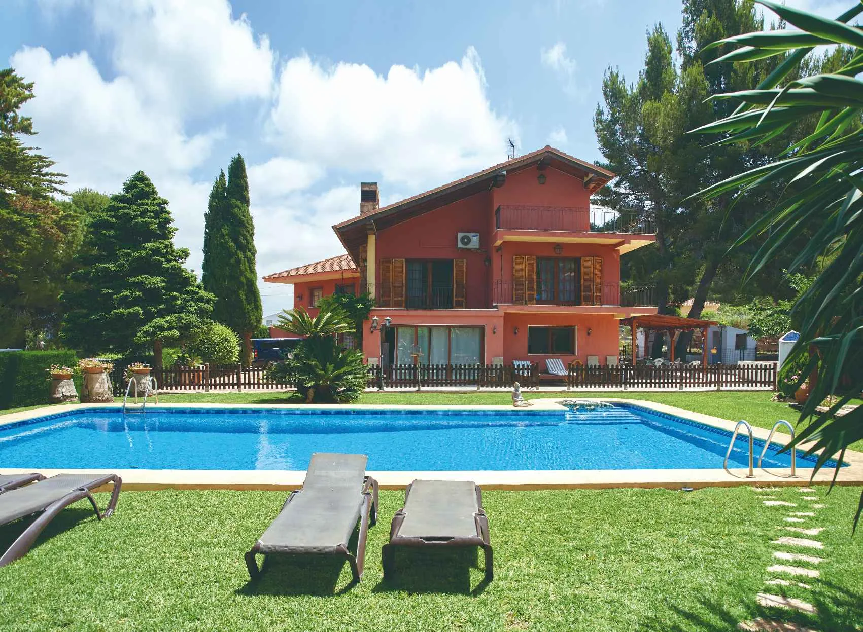 Red house with a pool