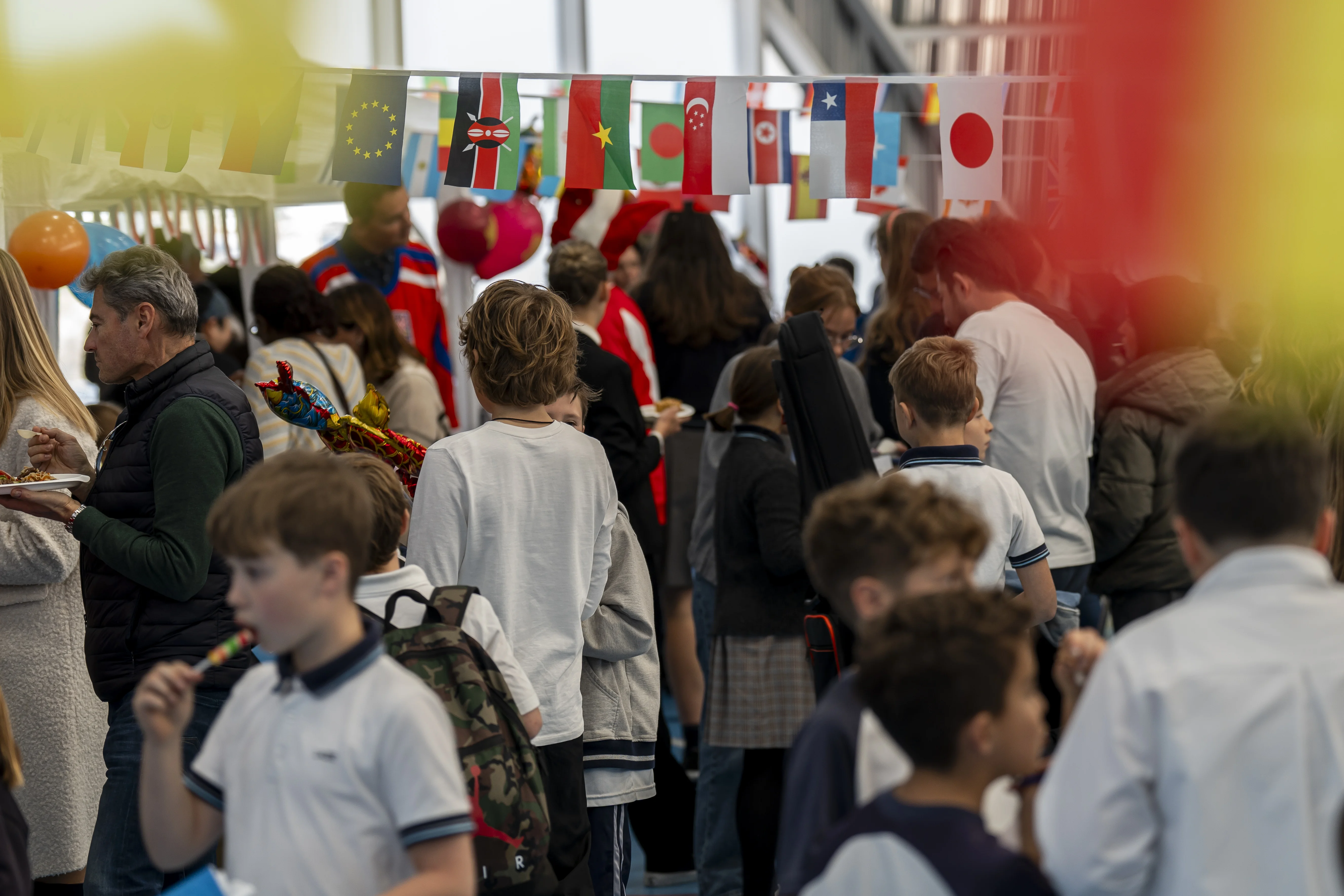 People walking under flags of different countries