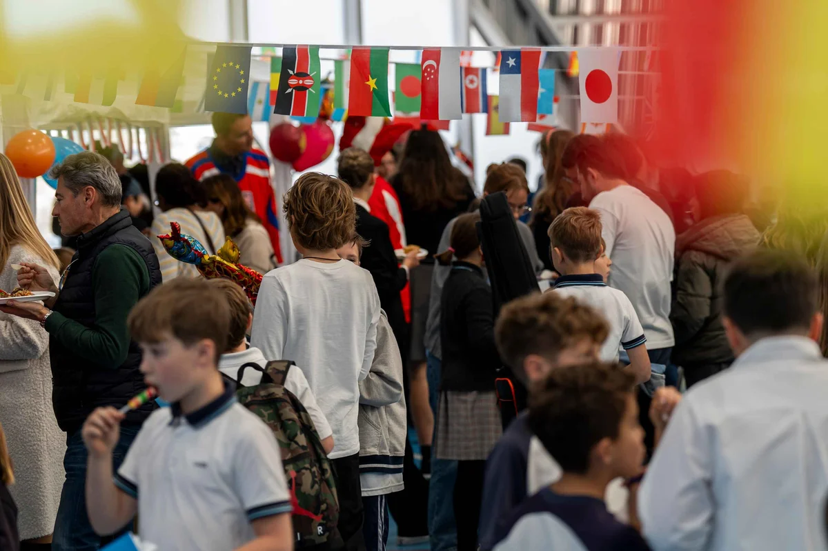 People walking under flags of different countries