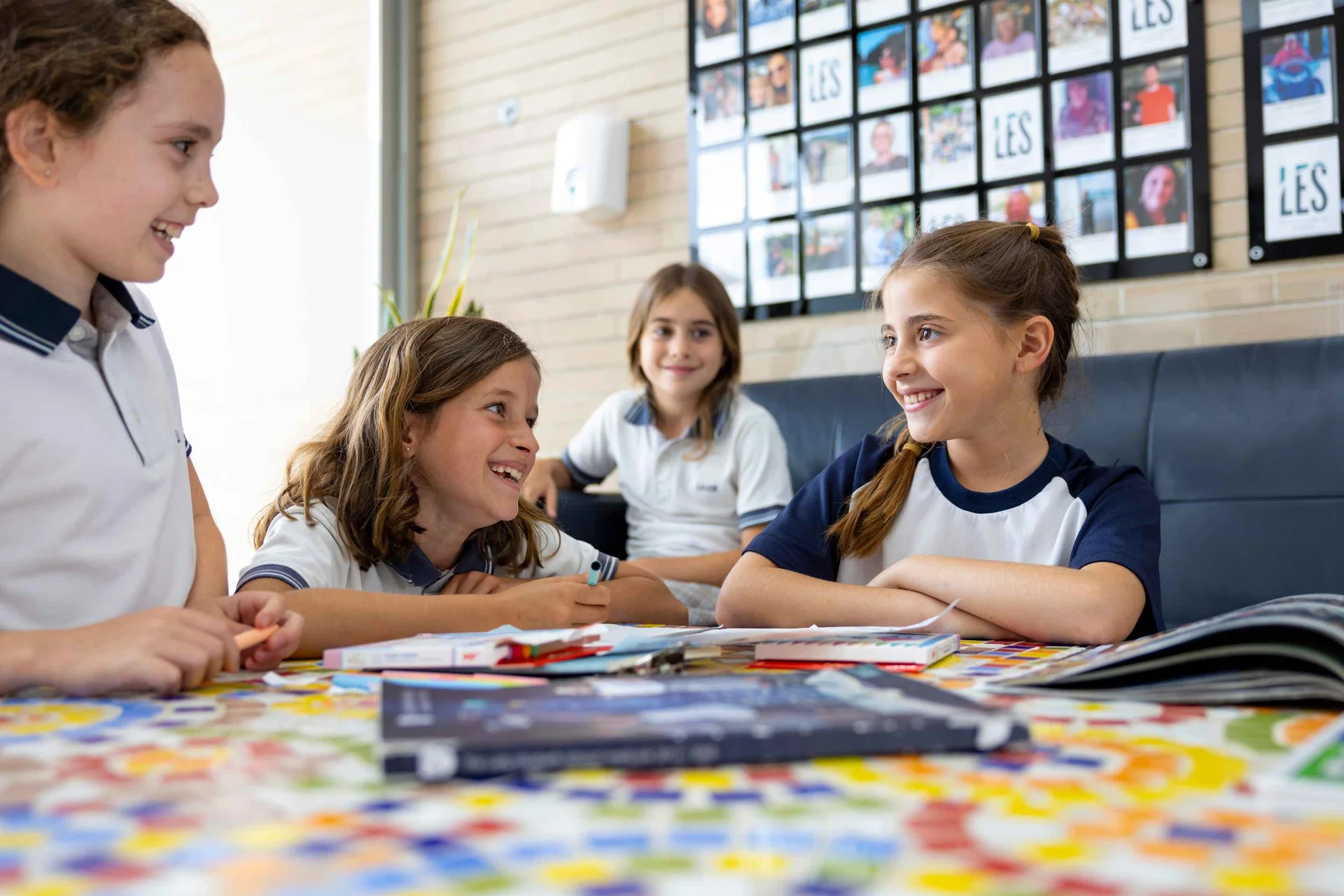 Four students smiling each other