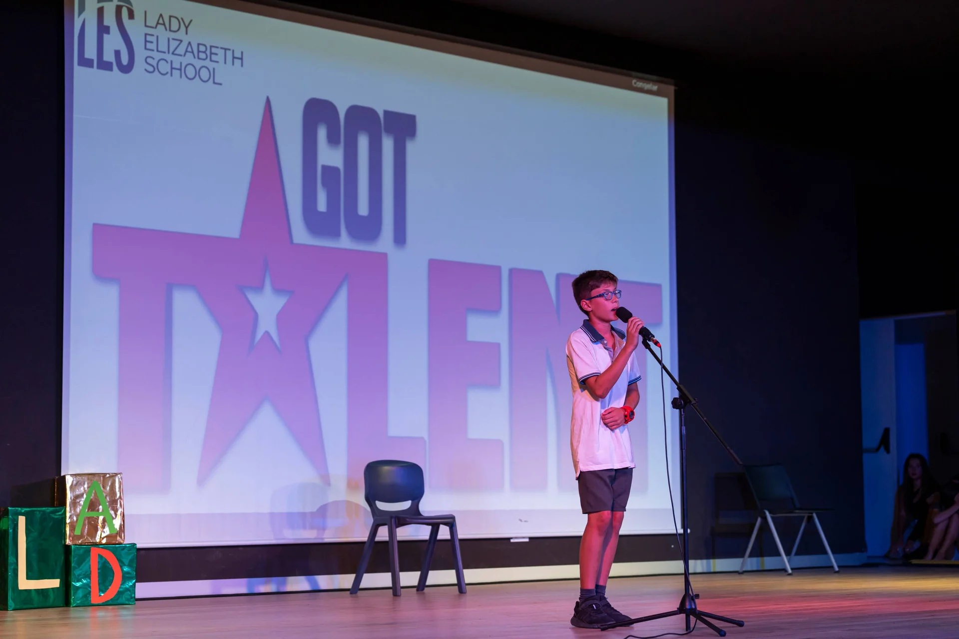 Student singing on a stage 