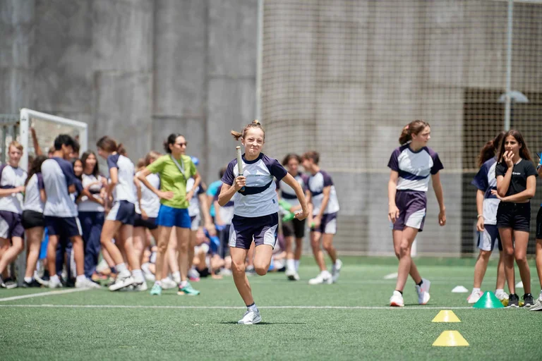 student runs during a relay game