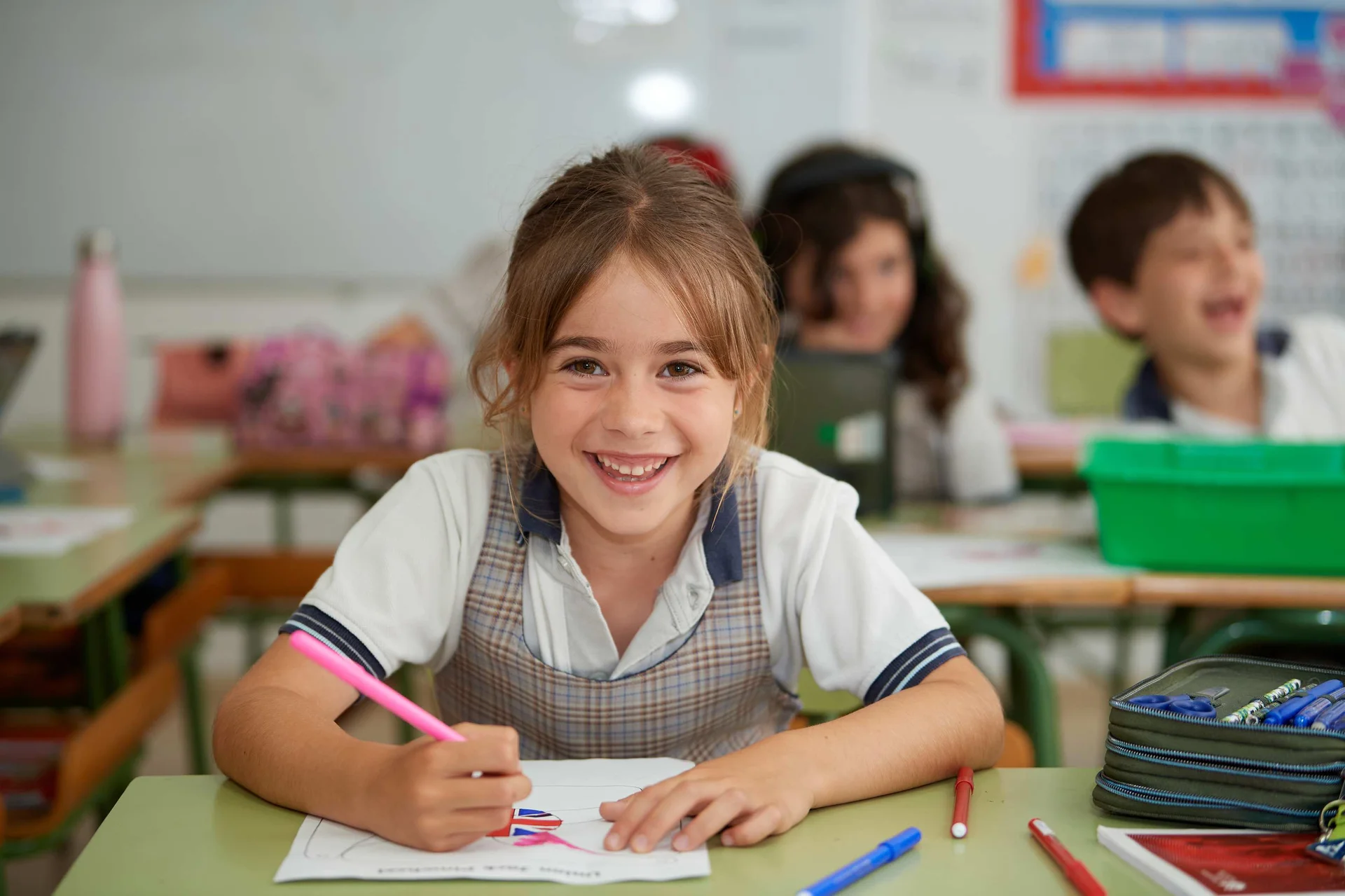 student coloring on a paper in the classroom 