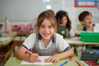 student coloring on a paper in the classroom 